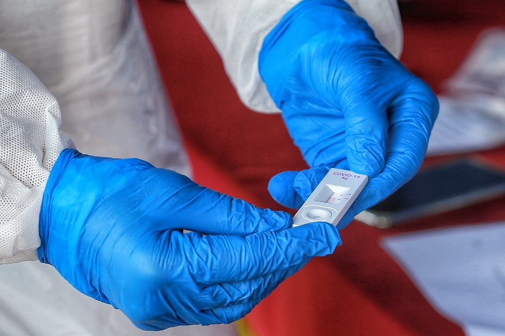 Health workers collect swab samples to test for Covid-19 at Dewan Kebajikan Gombak Setia February 20, 2021. — Picture by Ahmad Zamzahuri