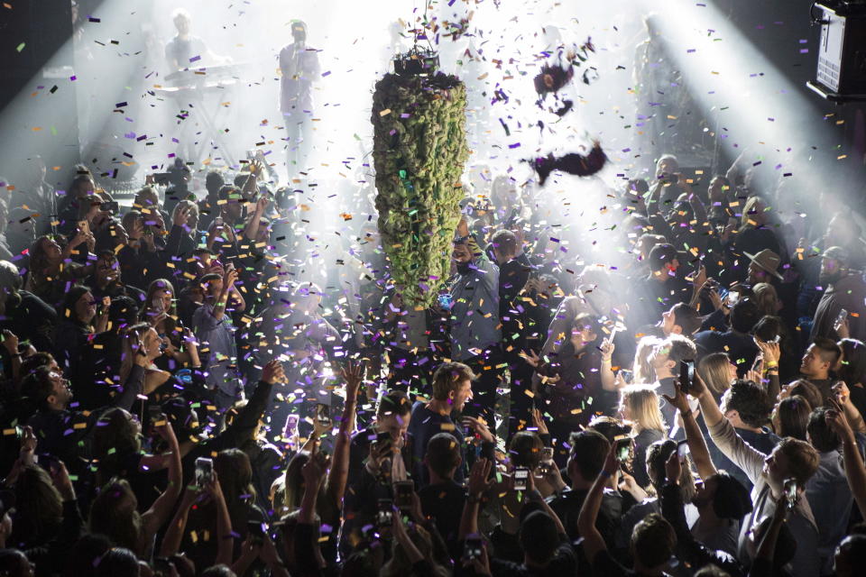 FILE - In this Oct. 17, 2018, file photo, a depiction of a cannabis bud drops from the ceiling at Leafly's countdown party in Toronto, as midnight passes and marks the first day of the legalization of cannabis across Canada. China has become the latest Asian country to warn its citizens in Canada about marijuana after it was legalized for recreational use there. (Chris Young/The Canadian Press via AP, File)