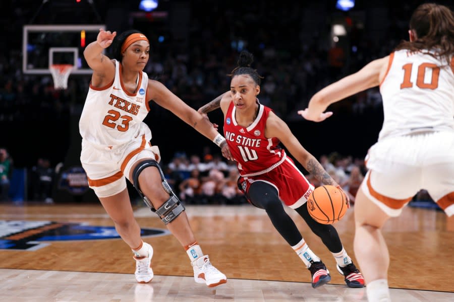 North Carolina State guard Aziaha James (10) drives to the basket as Texas forward Aaliyah Moore defends during the second half of an Elite Eight college basketball game in the women’s NCAA Tournament, Sunday, March 31, 2024, in Portland, Ore. (AP Photo/Howard Lao)