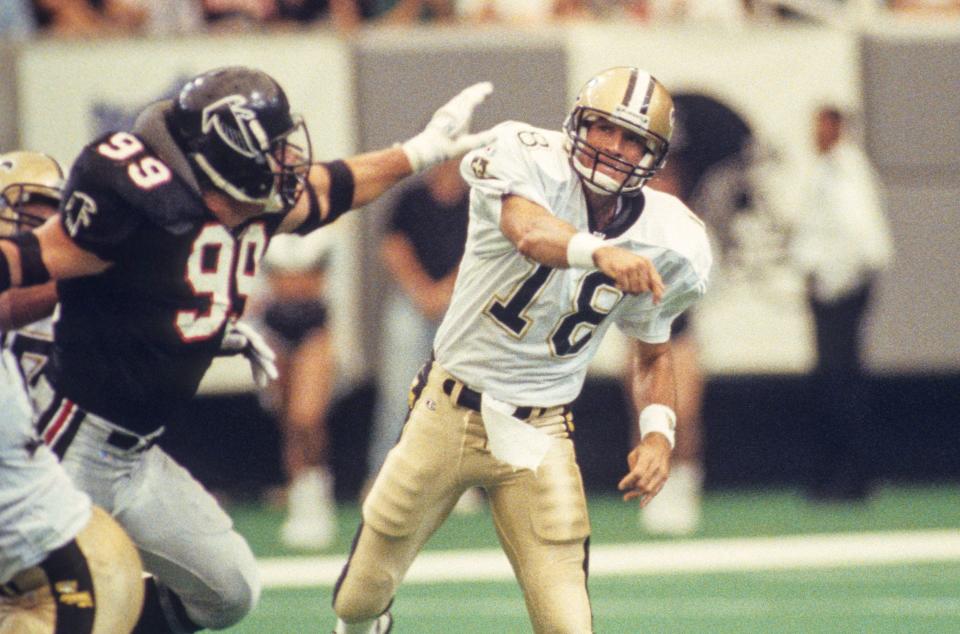 Sep 12, 1993; Atlanta, GA, USA; FILE PHOTO; New Orleans Saints quarterback Wade Wilson (18) throws the ball against Atlanta Falcons linebacker Tim Green (99) at the Georgia Dome. Mandatory Credit: Manny Rubio-USA TODAY NETWORK