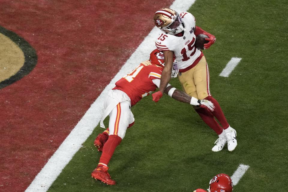 San Francisco 49ers wide receiver Jauan Jennings (15) scores past Kansas City Chiefs safety Mike Edwards (21) during the second half of the NFL Super Bowl 58 football game Sunday, Feb. 11, 2024, in Las Vegas. (AP Photo/Charlie Riedel)