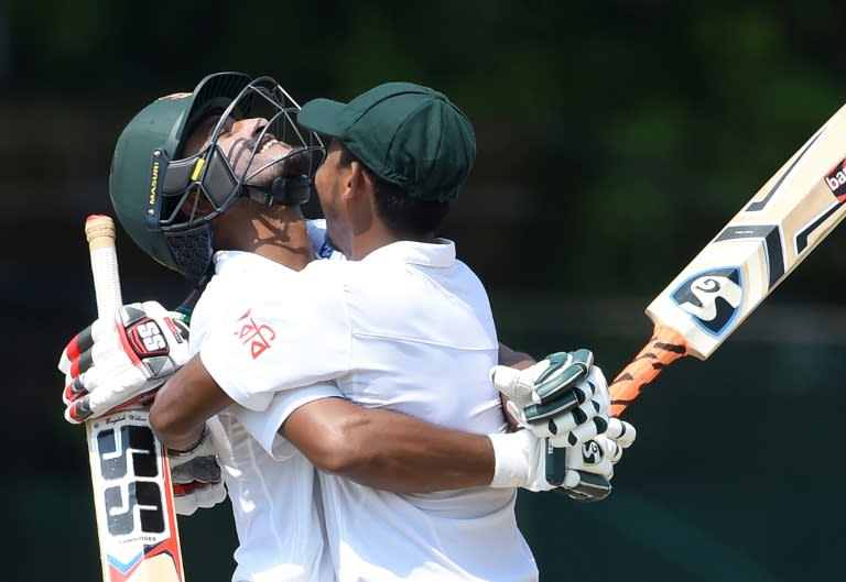 Bangladesh batsman Shakib Al Hasan (left) is embraced by teammate Mosaddek Hossain after reaching his century on the third day of the second Test against Sri Lanka in Colombo on March 17, 2017