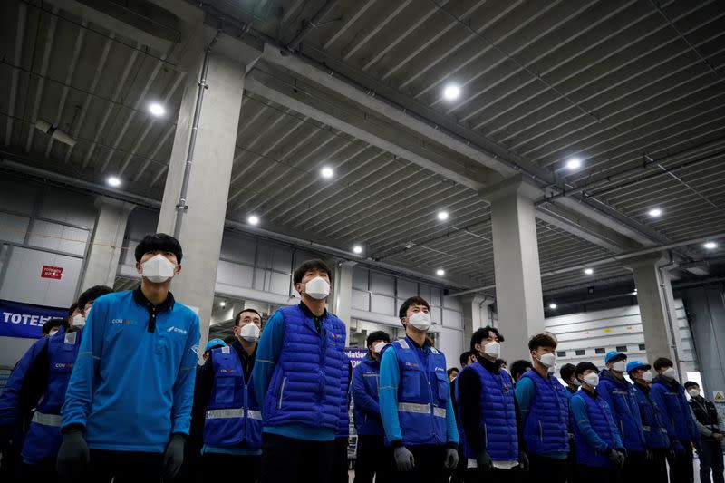 A delivery man for Coupang Jung Im-hong wearing a mask to prevent contracting the coronavirus, gets ready to deliver packages in Incheon