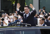 South Korea's new President Yoon Suk Yeol waves from a car after the Presidential Inauguration outside the National Assembly in Seoul, South Korea, Tuesday, May 10, 2022. (Ha Sa-hun/Yonhap via AP)