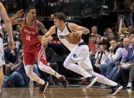 Dec 8, 2018; Dallas, TX, USA; Dallas Mavericks forward Luka Doncic (77) dribbles the ball past Houston Rockets guard Gerald Green (14) during the second half at the American Airlines Center. Jerome Miron-USA TODAY Sports