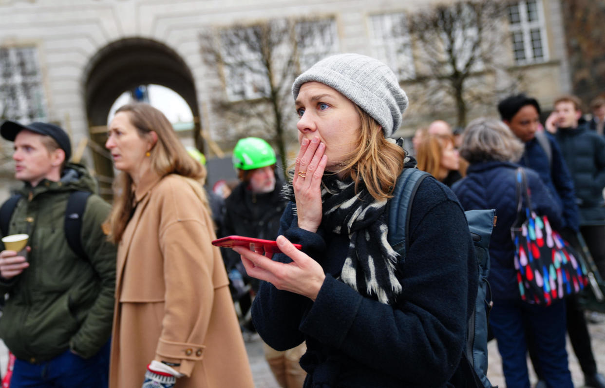 People react to a fire in the historic Boersen building in central Copenhagen, Denmark, on April 16, 2024.  / Credit: IDA MARIE ODGAARD/Ritzau Scanpix/AFP via Getty Images