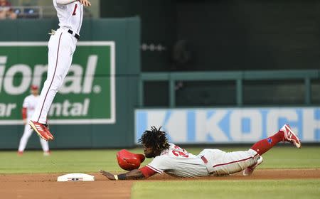 Jun 24, 2018; Washington, DC, USA; Philadelphia Phillies center fielder Odubel Herrera (37) slides under Washington Nationals shortstop Trea Turner (7) to steal second base during the first inning at Nationals Park. Mandatory Credit: Brad Mills-USA TODAY Sports