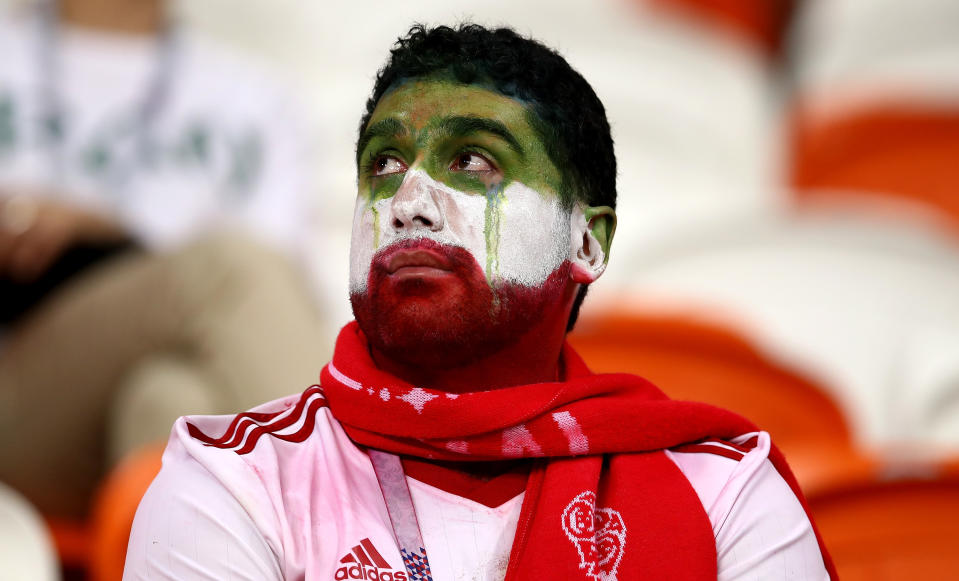 <p>An Iran supporter shows his emotions following defeat during the 2018 FIFA World Cup Russia group B match between Iran and Portugal at Mordovia Arena on June 25, 2018 in Saransk, Russia. (Photo by Maja Hitij – FIFA/FIFA via Getty Images) </p>