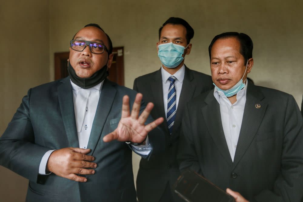 Lawyer Hamidi Mohd Noh (left) speaks to reporters at the Kuala Lumpur High Court July 9, 2020. — Picture by Ahmad Zamzahuri