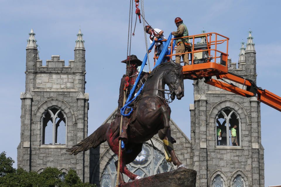 FILE - Crews attach straps to the statue Confederate General J.E.B. Stuart on Monument Avenue Tuesday July 7, 2020, in Richmond, Va. A Virginia special prosecutor has found no wrongdoing in the awarding of a $1.8 million contract for the removal of Richmond's Confederate statues last summer. The prosecutor said in a news release Wednesday, July 28, 2021, that he had reviewed the findings of a state police investigation and found no criminal activity. (AP Photo/Steve Helber, File)