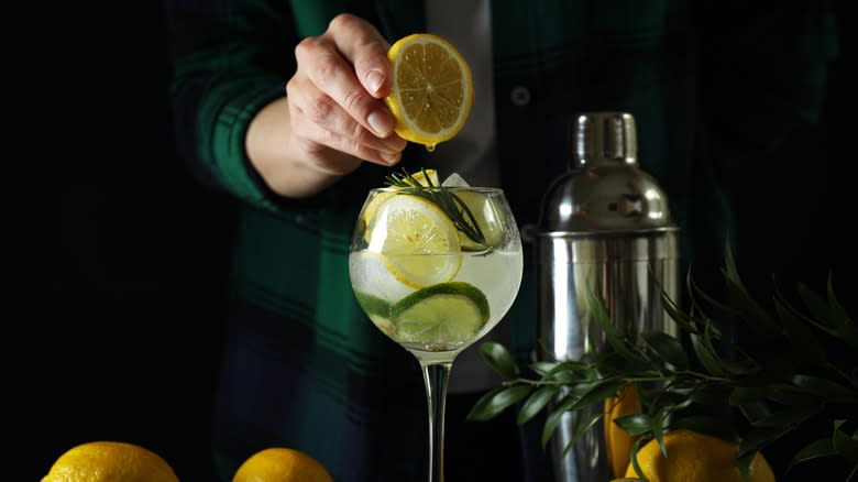 bartender squeezing citrus