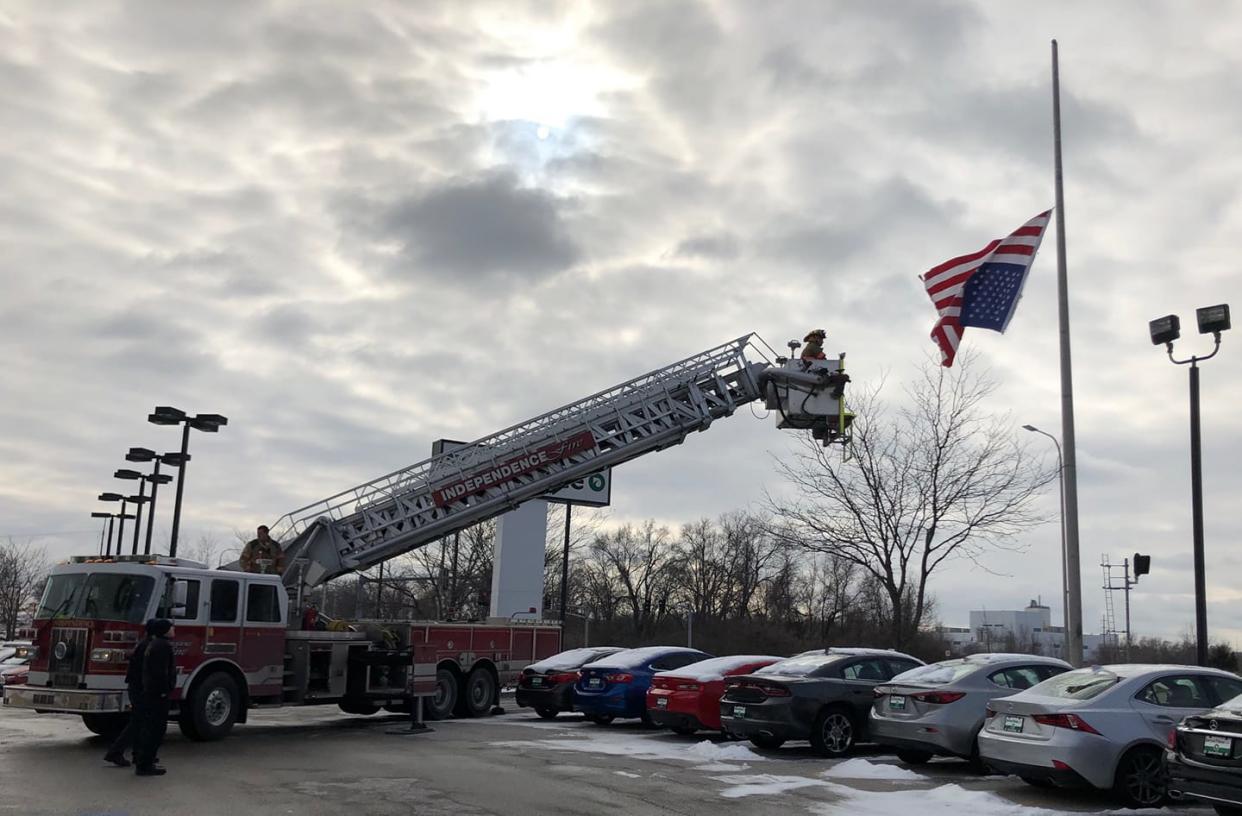 A police officer called in reinforcements to help fix an upside-down American flag. (Photo: Facebook)