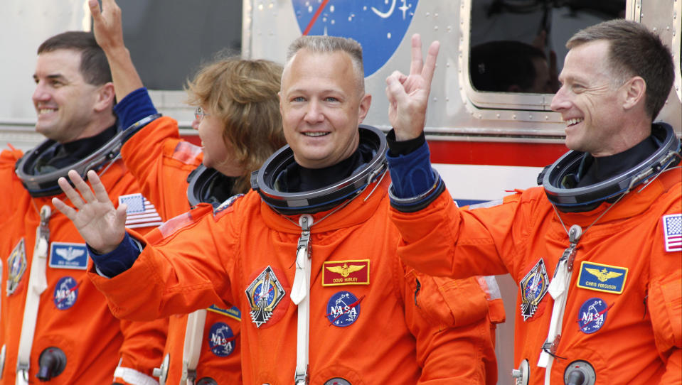 FILE - In this Friday, July 8, 2011 file photo, space shuttle Atlantis astronauts, from left, mission specialists Rex Walheim and Sandy Magnus, pilot Doug Hurley and commander Chris Ferguson, wave as they leave the operations and check-out building on the way to the pad at the Kennedy Space Center in Cape Canaveral, Fla. Atlantis is the 135th and final space shuttle launch for NASA. (AP Photo/Terry Renna)