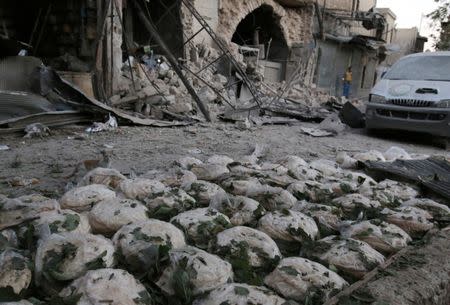 Stacks of bread are seen at a damaged site after an airstrike in the rebel-held Bab al-Maqam neighborhood of Aleppo, Syria. REUTERS/Abdalrhman Ismail