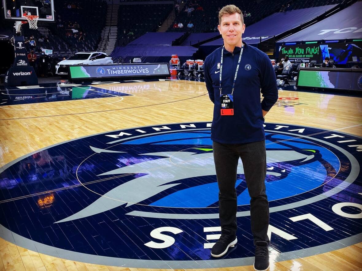 Luke Corey, a Mount Saint Vincent University graduate, is shown at half-court of the Target Center, the arena the Minnesota Timberwolves call home. (Submitted by Luke Corey - image credit)