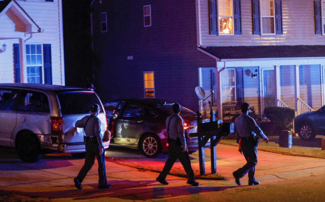 Raleigh Police officers walk door to door checking on residents in the Hedingham neighborhood and Neuse River Trail area in Raleigh after 5 people were shot and killed Thursday, Oct. 13, 2022.