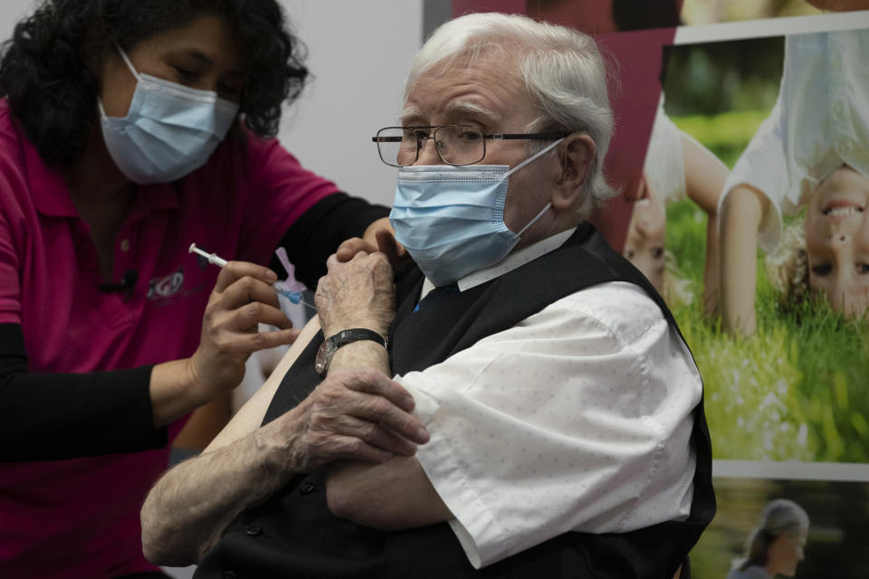 Okko Molenkamp, 94, is injected with a COVID-19 vaccine in Apeldoorn, Netherlands, Tuesday, Jan. 26, 2021. Dutch authorities began vaccinating the first of thousands of people aged over 90 years who still live at home. (AP Photo/Peter Dejong)