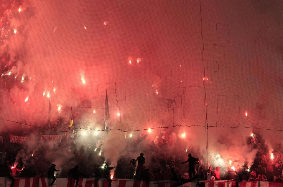 Olympiakos' fans hold flares during a Greek League soccer match against Panathinaikos at Georgios Karaiskakis stadium, in Piraeus port, near Athens, on Sunday, March 2, 2014. (AP Photo/Thanassis Stavrakis)