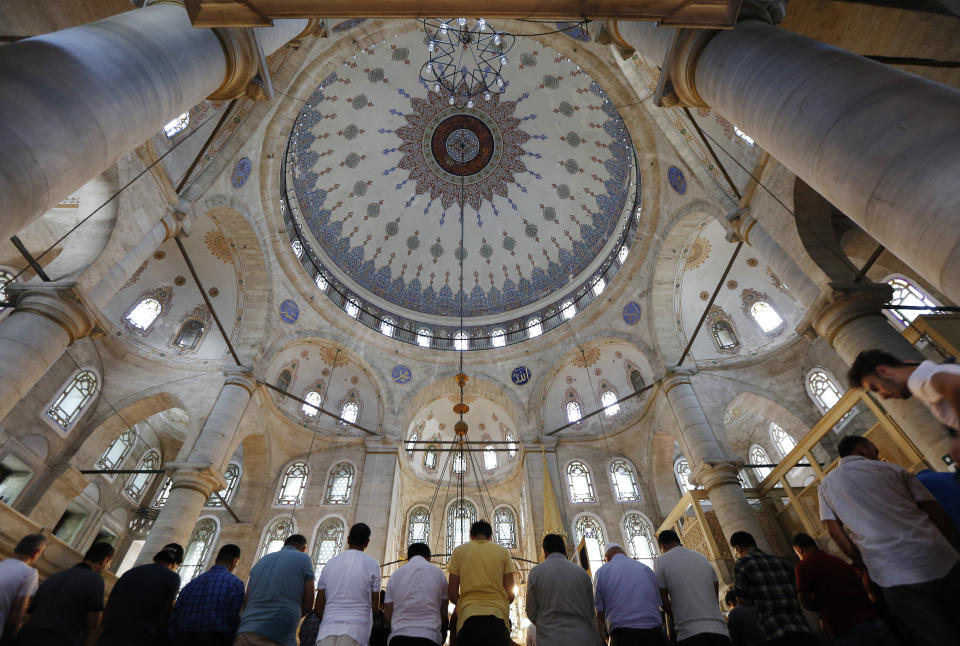 People pray in a mosque in Istanbul, Wednesday, Aug. 15, 2018. The Turkish government’s framing of its problems as an epic battle for sovereignty against outside enemies, particularly U.S. President Donald Trump, resonates among core supporters, even as fears grow that further falls of the Turkish lira could threaten bankruptcies among Turkish firms carrying high foreign currency debt. (AP Photo/Lefteris Pitarakis)