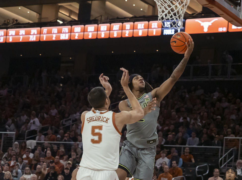 Baylor guard Jayden Nunn, right, shoots over Texas forward Kadin Shedrick, left, during the first half of an NCAA college basketball game, Saturday, Jan. 20, 2024, in Austin, Texas. (AP Photo/Michael Thomas)