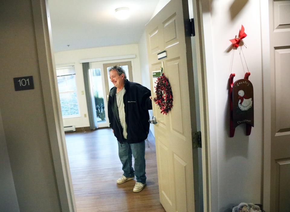 Jeff Sandler opens the door to the apartment he and his wife, Tami, finally secured Monday, Dec. 11, 2023. The couple were homeless and living the woods for 10 months.