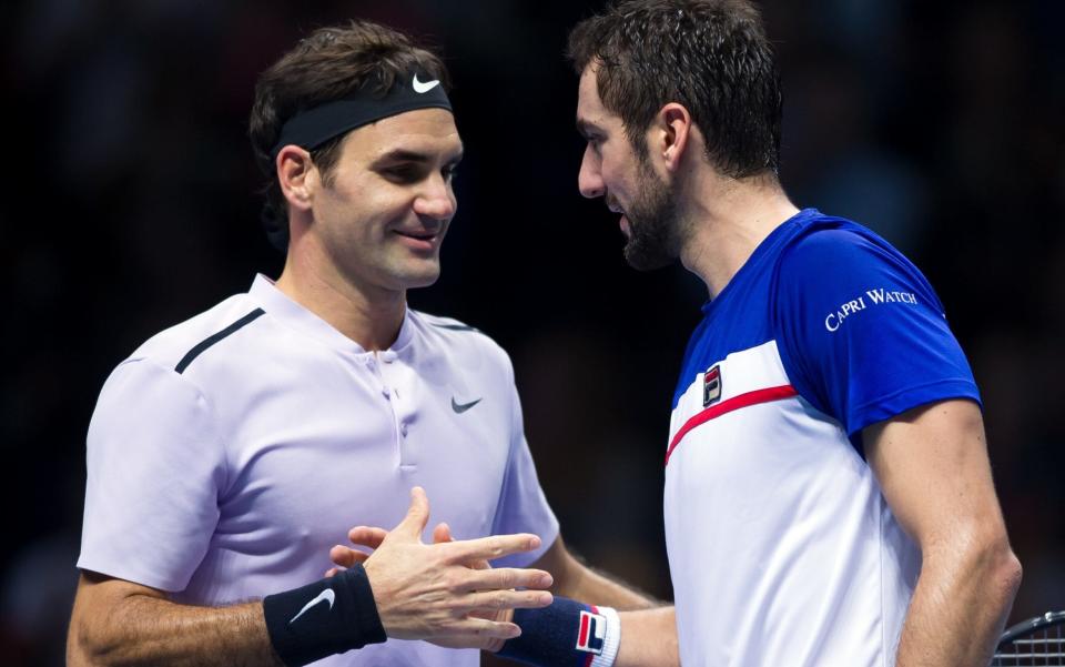 Roger Federer (left) shakes hands with Marin Cilic following their three-set encounter in London - CameraSport