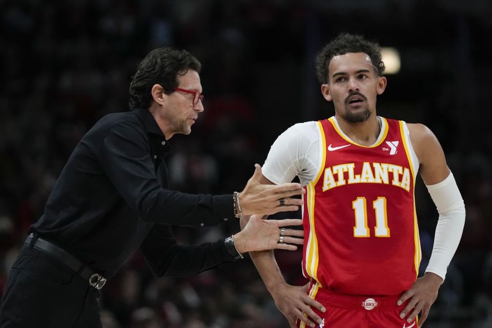 Atlanta Hawks coach Quin Snyder talks to guard Trae Young during the first half of the team's NBA basketball game against the Chicago Bulls on Tuesday, Dec. 26, 2023, in Chicago. (AP Photo/Erin Hooley)