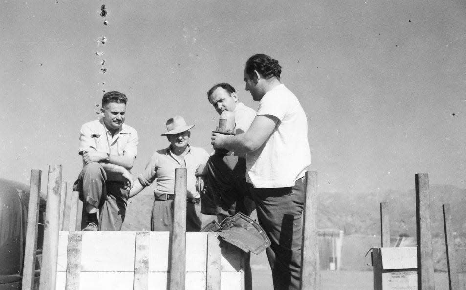 In 1948, Al Schwimmer (second from right) speaks with his chief mechanic, Willie Sosnow (right), at the Lockheed Air Terminal in Burbank, Calif.