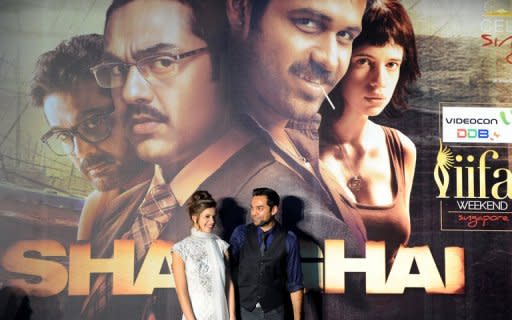 Bollywood actress Kalki Koechlin (L) poses with actor Abhay Deol (R) after arriving at the green carpet to attend the premier of their new movie 'Shanghai' during the International Indian Film Academy (IIFA) awards event in Singapore. The Hindi political thriller hits cinemas June 8, raising awkward questions about India's development