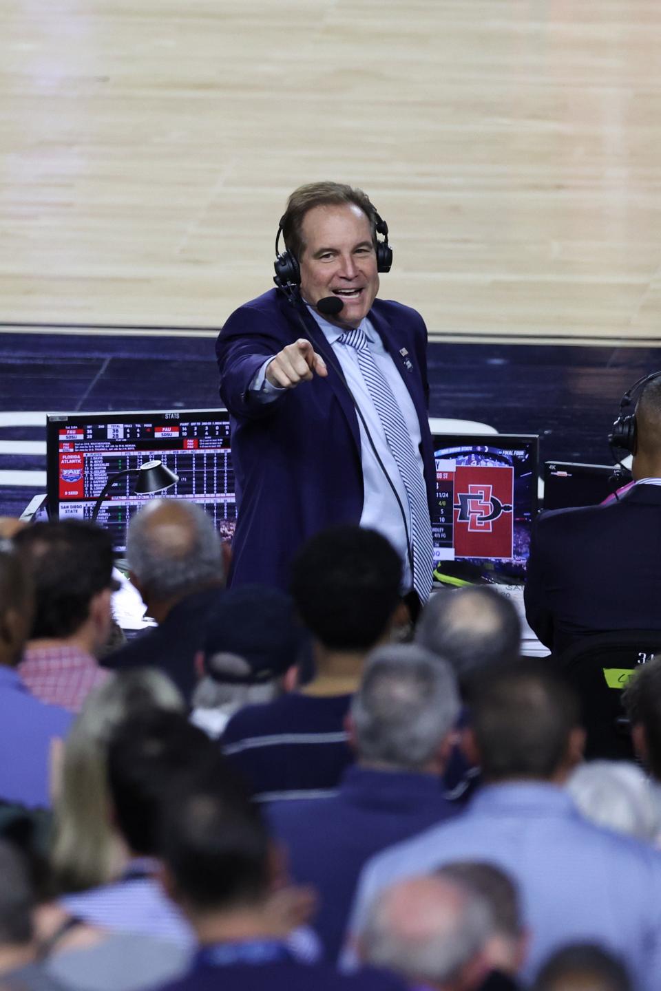 Jim Nantz points to the crowd during the 2023 Final Four.