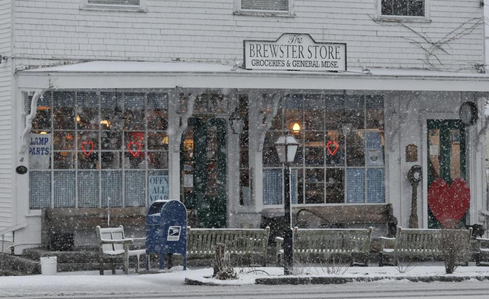 Snow falls in front of the Brewster Store decorated with hearts ahead of Valentine's Day.