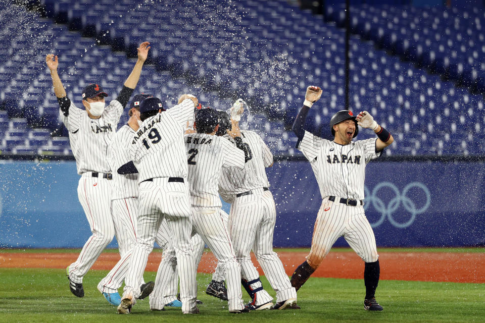 <p>YOKOHAMA, JAPAN - AUGUST 02: Team Japan celebrates after Takuya Kai #10 hit a game-winning single in the tenth inning to defeat Team United States 7-6 during the knockout stage of men's baseball on day ten of the Tokyo 2020 Olympic Games at Yokohama Baseball Stadium on August 02, 2021 in Yokohama, Kanagawa, Japan. (Photo by Koji Watanabe/Getty Images)</p> 