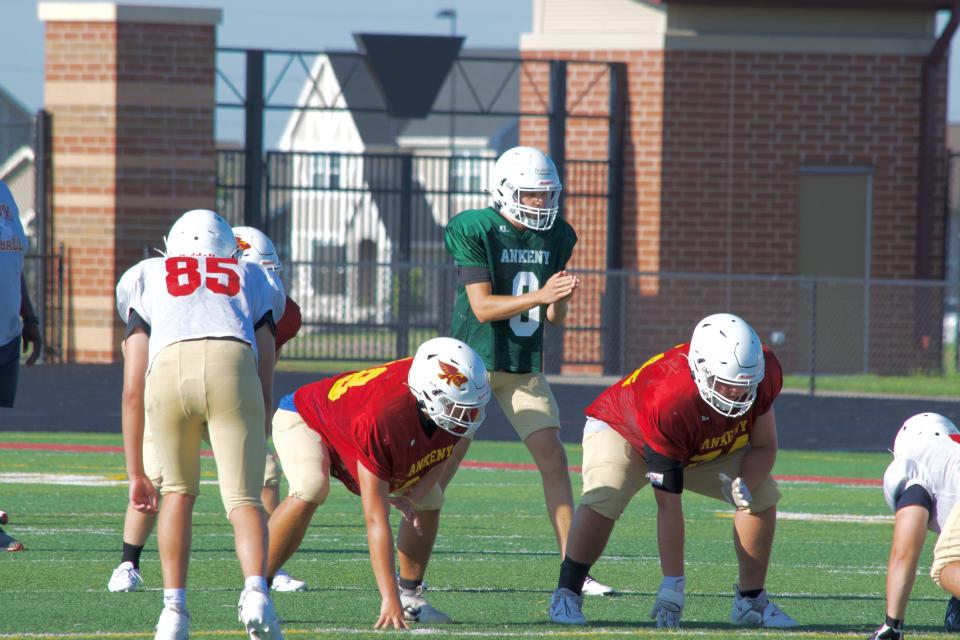 Ankeny football players participate in a drill during the first week of practice. The Hawks returned five starters between offense and defense.