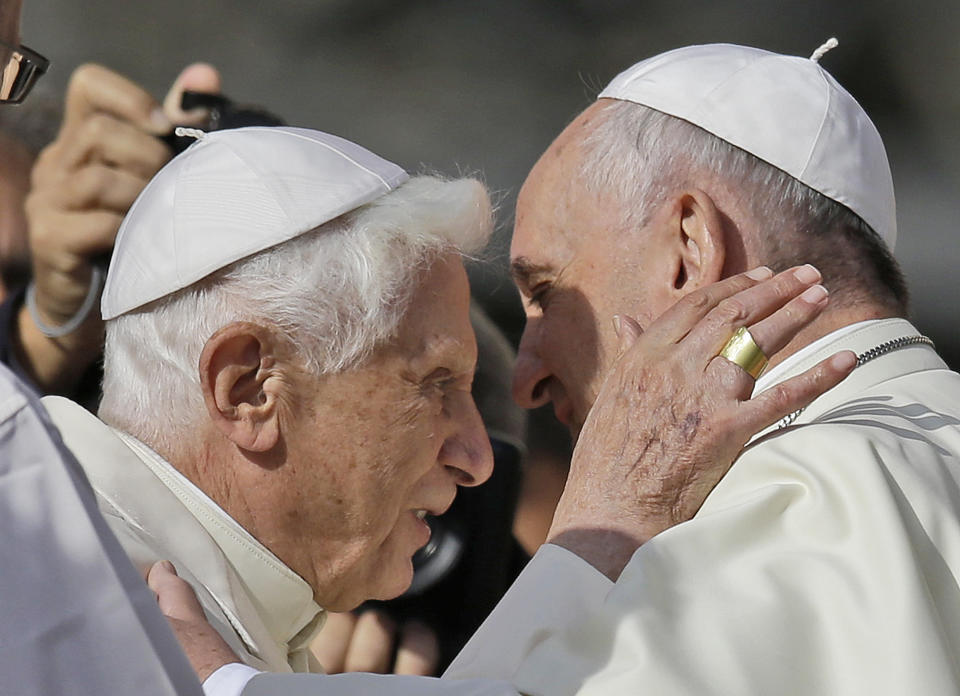 FILE - Pope Francis, right, hugs Pope Emeritus Benedict XVI prior to the start of a meeting with elderly faithful in St. Peter's Square at the Vatican, Sunday, Sept. 28, 2014. Pope Benedict XVI’s 2013 resignation sparked calls for rules and regulations for future retired popes to avoid the kind of confusion that ensued. Benedict, the German theologian who will be remembered as the first pope in 600 years to resign, has died, the Vatican announced Saturday Dec. 31, 2022. He was 95. (AP Photo/Gregorio Borgia, File )