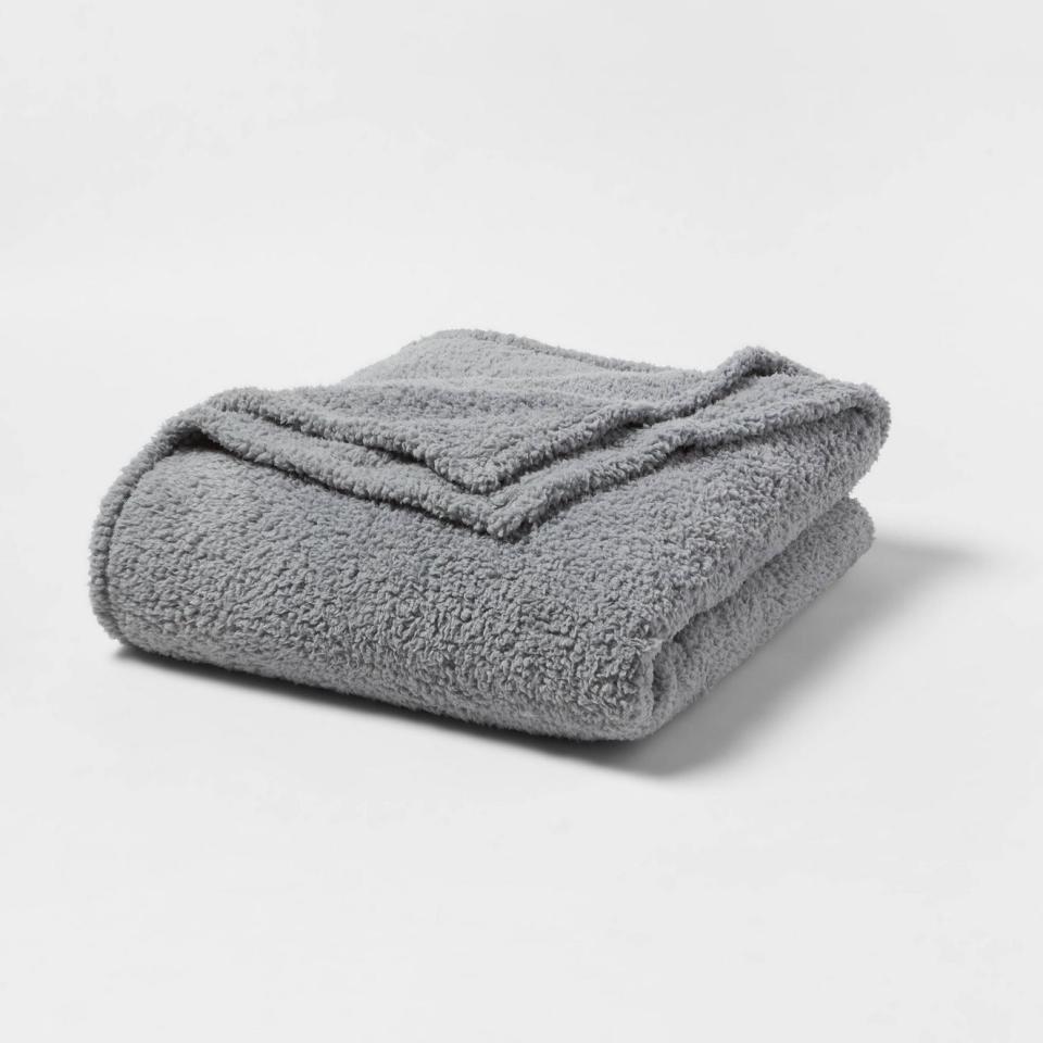 Soft-textured gray blanket neatly folded, suitable for home decor or warmth