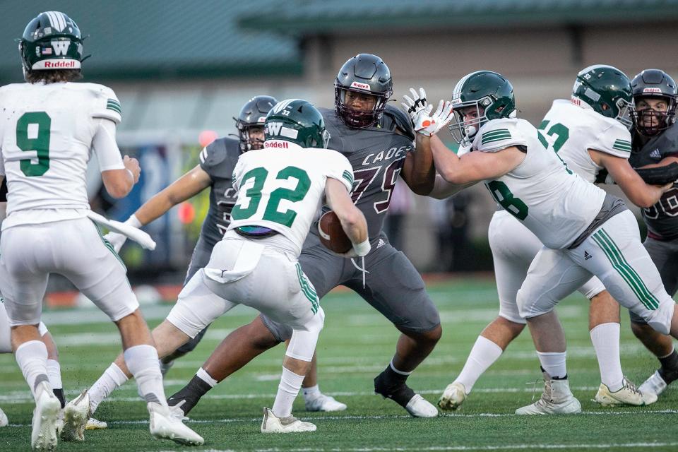 Benedictine’s Cole Semien fights through blockers to make the tackle