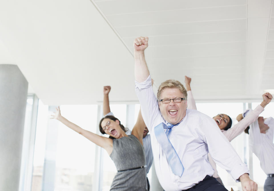 Business people cheering with their hands in the air