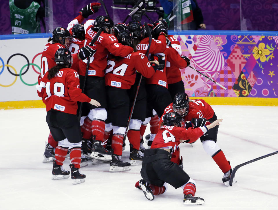 Canada celebrates after their 3-2 win in overtime against USA in the women's gold medal ice hockey game at the 2014 Winter Olympics, Thursday, Feb. 20, 2014, in Sochi, Russia. (AP Photo/Petr David Josek)