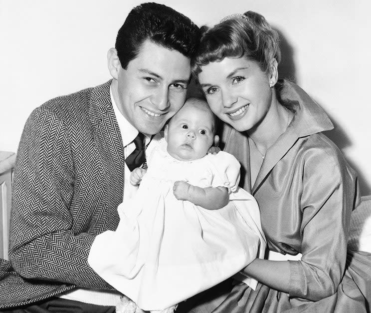 Eddie Fisher and Debbie Reynolds hold their baby daughter, Carrie Frances Fisher, as the pose for a photo in the Hollywood area of Los Angeles. On Tuesday, Dec. 27, 2016, a publicist says Carrie Fisher has died at the age of 60. (Credit: AP Photo) 