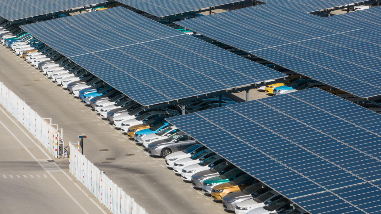 Aerial view of cars parked under solar panels.
