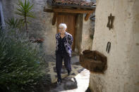Rabbi Barbara Aiello walks the courtyard of her "Ner Tamid del Sud" (The Eternal Light of the South) synagogue and home in Serrastretta, southern Italy, Friday, July 8, 2022. From a rustic, tiny synagogue she fashioned from her family's ancestral home in this mountain village, American rabbi Aiello is keeping a promise made to her Italian-born father: to reconnect people in this southern region of Calabria to their Jewish roots, links nearly severed five centuries ago when the Inquisition forced Jews to convert to Christianity. (AP Photo/Andrew Medichini)