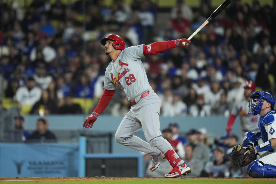 St. Louis Cardinals' Nolan Arenado watches after hitting a sacrifice fly during the eighth inning of a baseball game against the Los Angeles Dodgers Friday, March 29, 2024, in Los Angeles. (AP Photo/Jae C. Hong)