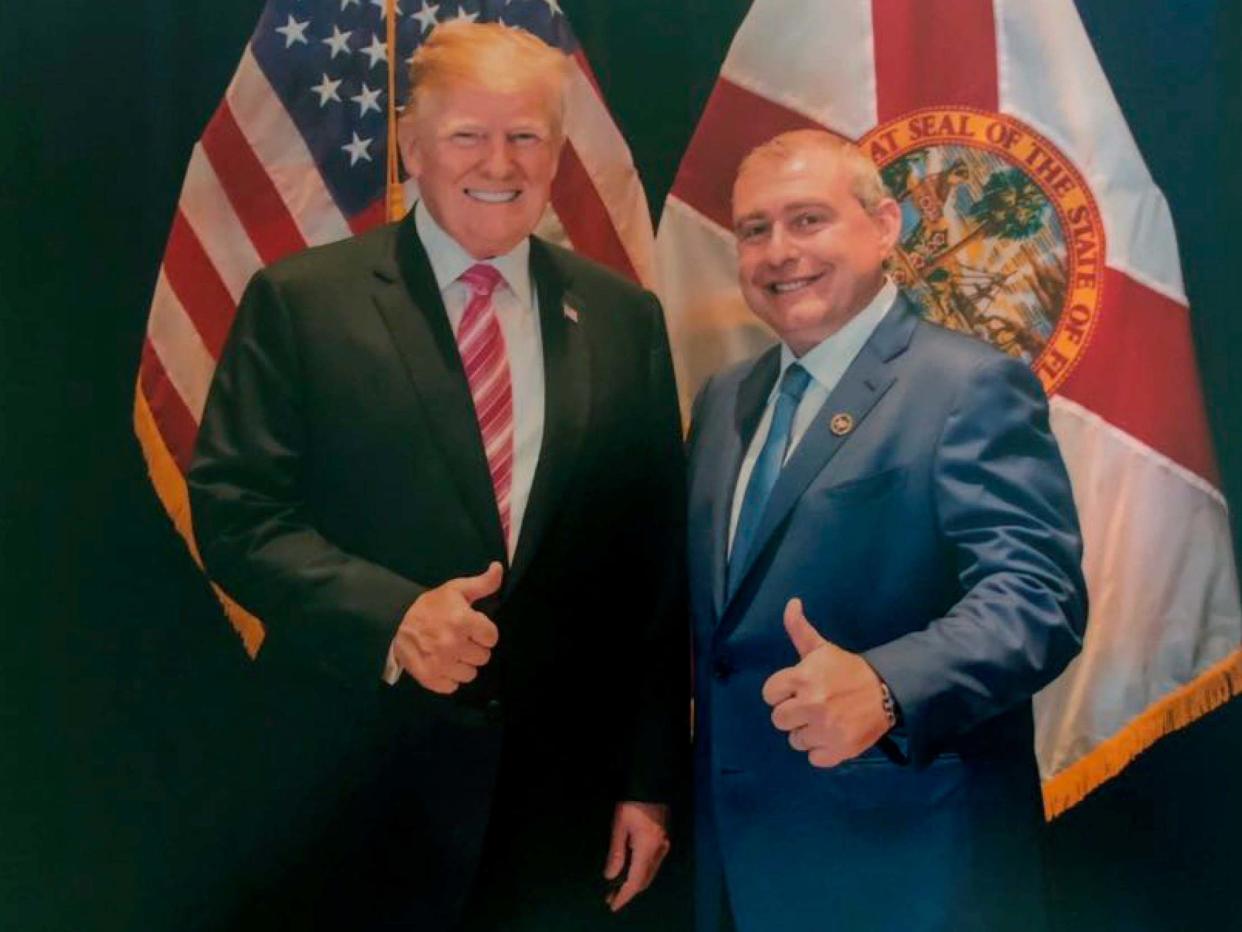 Image released by House Judiciary Committee in the impeachment probe shows a photo of Lev Parnas with Mr Trump in Florida: House Judiciary Committee via AP