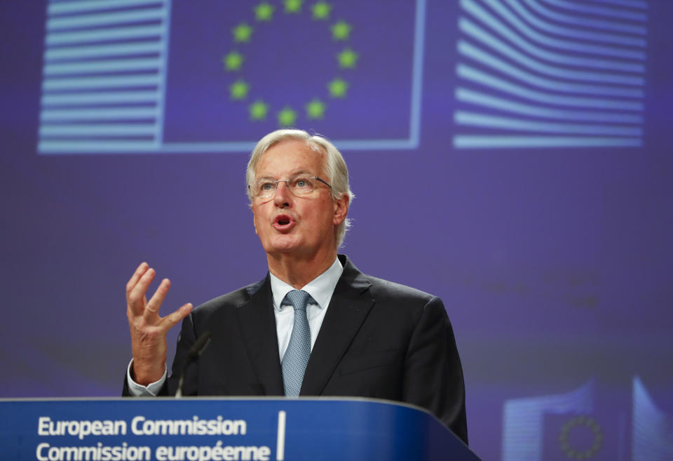 European Union chief Brexit negotiator Michel Barnier looks at his watch prior to speaking during a media conference at EU headquarters in Brussels, Thursday, Oct. 17, 2019. The European Union says Brexit negotiations are plowing on after intense talks in recent days, as EU leaders converge on Brussels for a key summit aimed at sealing a new divorce agreement. (AP Photo/Frank Augstein)