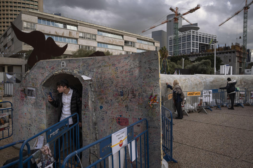 A man walks out from an installation simulating a tunnel in Gaza in an act of solidarity with hostages believed to be held underground by Hamas and calling for their return, in Tel Aviv, Israel, Wednesday, Jan. 31, 2024. (AP Photo/Oded Balilty)