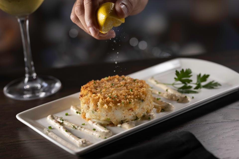 The jumbo lump crab cake appetizer at Eddie V's is sauteed Maryland style and served with a spicy chive remoulade.