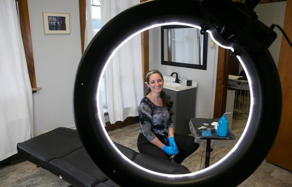 Emily Jackson, a permenant make up artist and owner of The Ink Loft, sits at one of the work stations inside of The Ink Loft on December 6, 2023, in Chillicothe, Ohio.