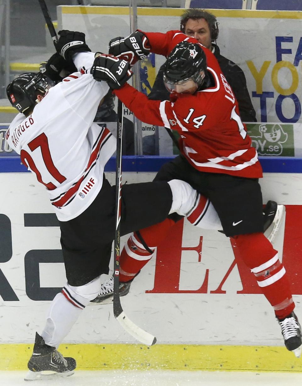 Canada's Taylor Leier (R) checks Switzerland's Yannick Rathgeb during the second period of their IIHF World Junior Championship ice hockey game in Malmo, Sweden, January 2, 2014. REUTERS/Alexander Demianchuk (SWEDEN - Tags: SPORT ICE HOCKEY)