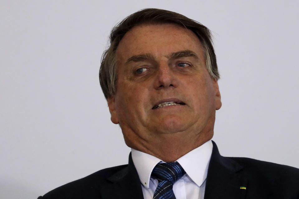 Brazil's President Jair Bolsonaro reacts during ceremony to present the government's agenda to the new elected mayors, at the Planalto Presidential Palace, in Brasilia, Brazil, Tuesday, Feb. 23, 2021. (AP Photo/Eraldo Peres)