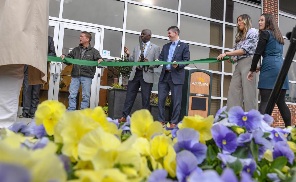 Mayor Terence Roberts, middle left, gets ready to cut the ceremonial ribbon with David McCuen, Francesca Milford, and Mary Haley Thompson and Jeff Roberts during the grand opening ceremony for the City of Anderson's 110 North Kitchen + Commissary in Anderson, on Feb. 29. Grant money from Appalachian Regional Commission ($500,000) and USDA Rural Business Development ($500,000) helps new food businesses start and grow their business in the space under the Whitner Street garage.